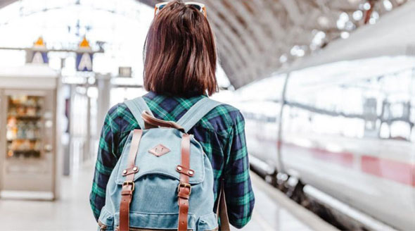 A woman with a backpack in a train station